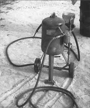 A moisture trap just past the tub is permanently plumbed at the sandblaster.